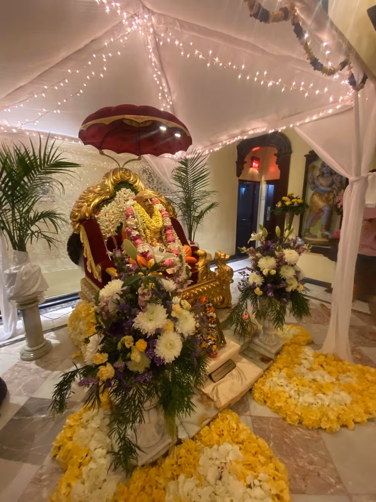 Beautifully decorated temple altar with flowers and lights